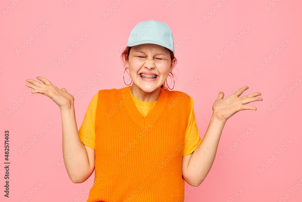 portrait of a young woman grimace earrings cap fashion isolated backgrounds unaltered portrait of a young woman grimace earrings cap fashion isolated backgrounds unaltered