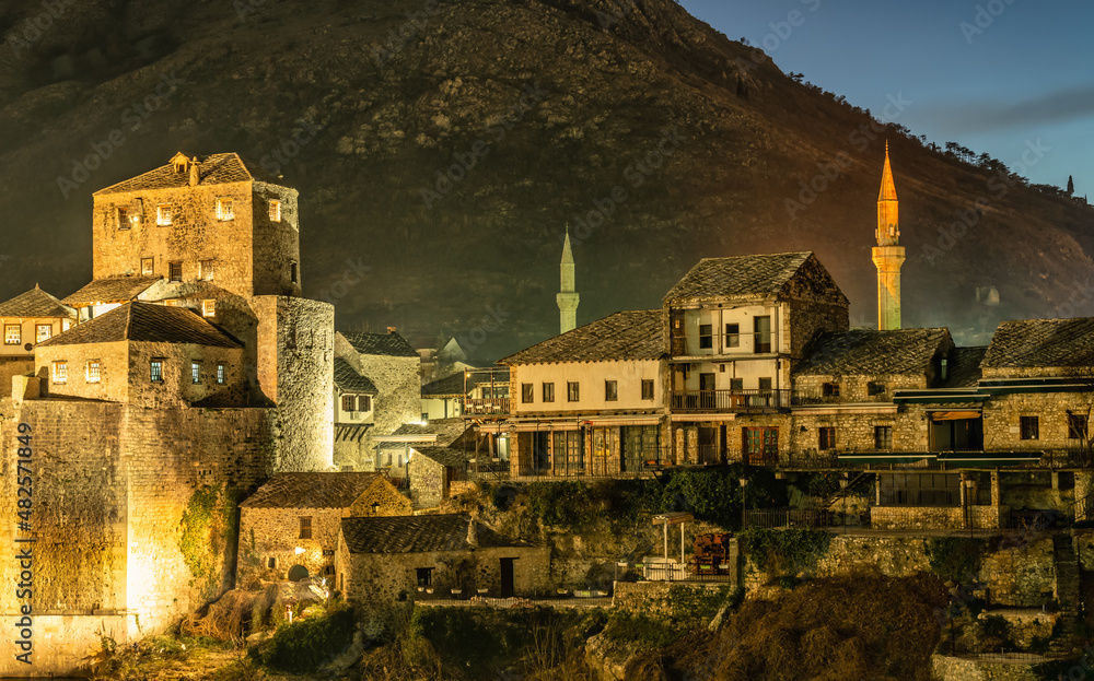 view of Mostar old town with bridge tower and mosque minarets.