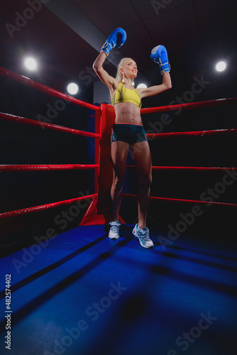 Sports Boxing Woman in box gloves sitting on ring © Oleg