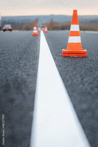 Fresh road markings with orange traffic cones
