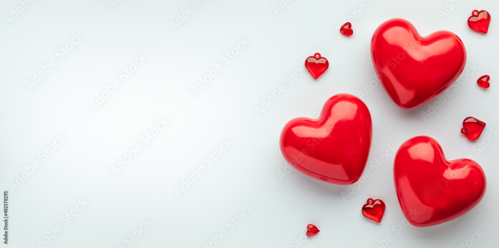 Valentine's day concept with red hearts on light blue background, top view, copy space. .