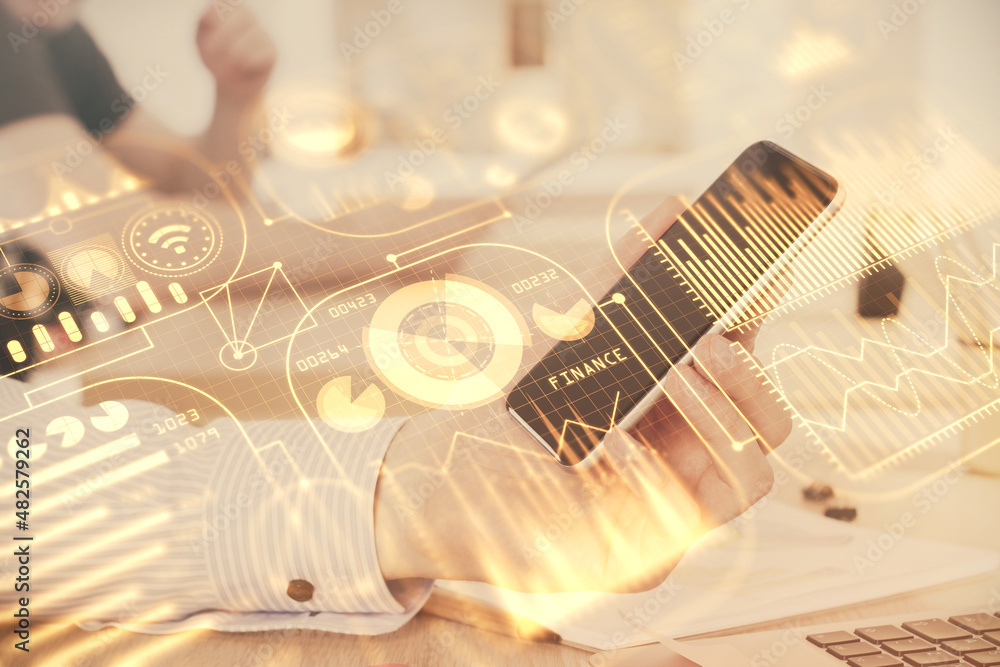 Double exposure of man's hands holding and using a digital device and tech theme hologram drawing. Technology concept. Double exposure of man's hands holding and using a digital device and tech theme hologram drawing. Technology concept.