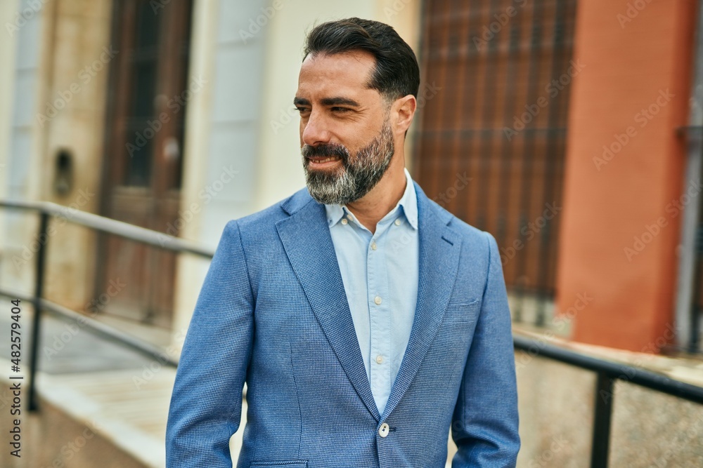Middle age businessman smiling happy standing at the city. Middle age businessman smiling happy standing at the city.