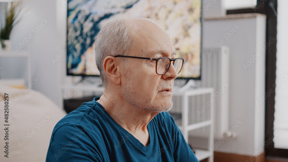 Close up of senior man doing wellness exercise and breathing while meditating after workout. Retired adult relaxing with meditation activity to practice yoga recreation and wellbeing. Close up of senior man doing wellness exercise and breathing while meditating after workout. Retired adult relaxing with meditation activity to practice yoga recreation and wellbeing.
