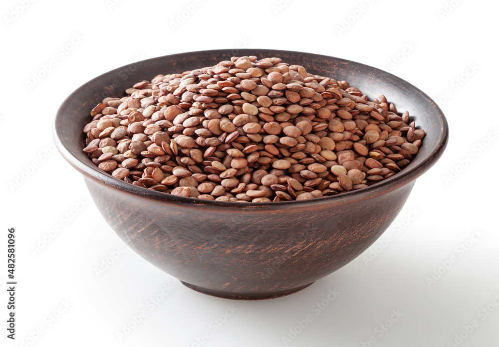 Uncooked green lentils in ceramic bowl isolated on white background with clipping path Uncooked green lentils in ceramic bowl isolated on white background with clipping path