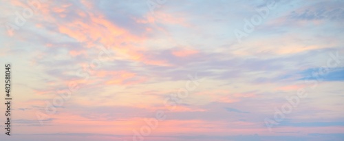 Clear sky, glowing cirrus and cumulus clouds after the storm, soft sunlight. Dramatic sunset cloudscape. Meteorology, weather, climate, heaven, peace. Graphic resources. Picturesque panoramic scenery