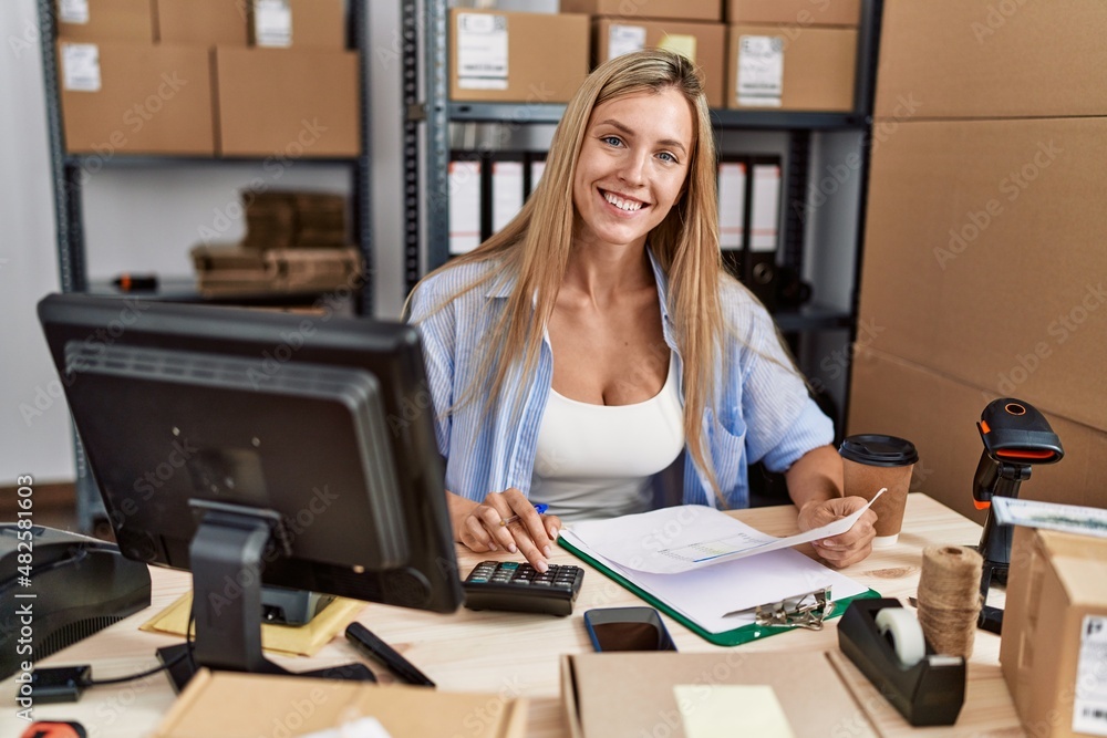 Young blonde woman ecommerce business worker working at office