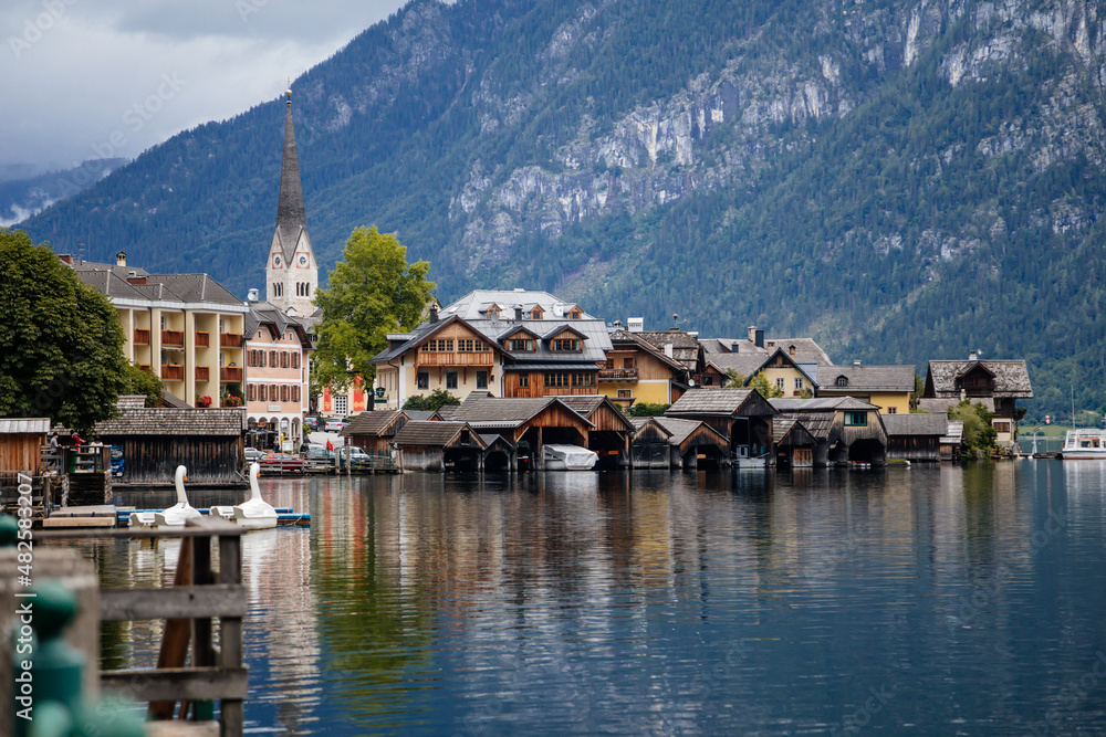 Hallstatt, Austria, 27 August 2021: Colorful scenic picturesque town street at summer day, mountain village at Alps, UNESCO heritage, traditional houses, wooden balconies, flowers in pots, water lake Hallstatt, Austria, 27 August 2021: Colorful scenic picturesque town street at summer day, mountain village at Alps, UNESCO heritage, traditional houses, wooden balconies, flowers in pots, water lake