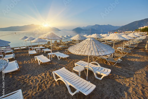 sandy beach without people and with sun loungers, umbrellas, palm trees, Marmaris © Ryzhkov Oleksandr