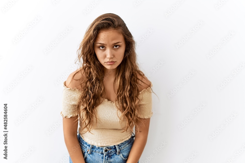 Beautiful hispanic woman standing over isolated while background skeptic and nervous, frowning upset because of problem. negative person. Beautiful hispanic woman standing over isolated while background skeptic and nervous, frowning upset because of problem. negative person.
