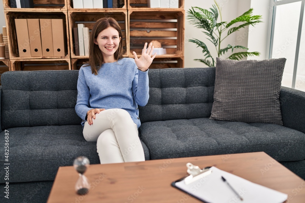 Young brunette woman at consultation office showing and pointing up with fingers number five while smiling confident and happy. Young brunette woman at consultation office showing and pointing up with fingers number five while smiling confident and happy.