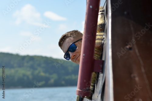 A man in sunglasses looks out the window of the Dragon pirate ship in Gdynia