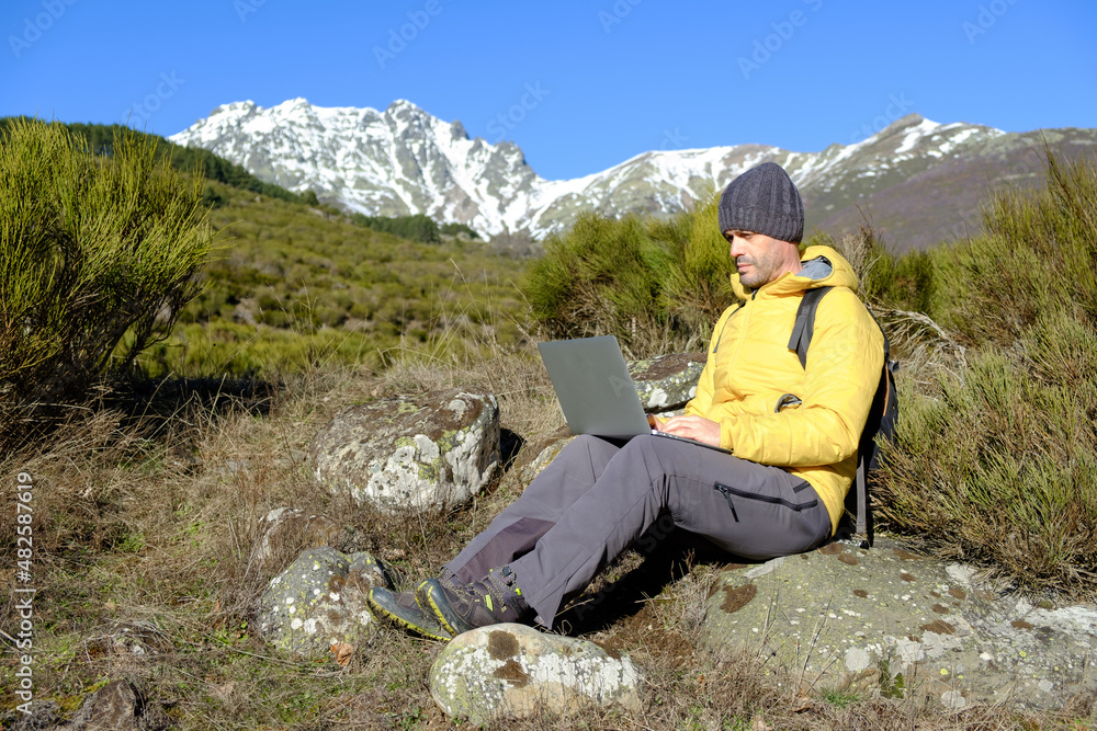 Man working with a laptop computer in nature. Health at work