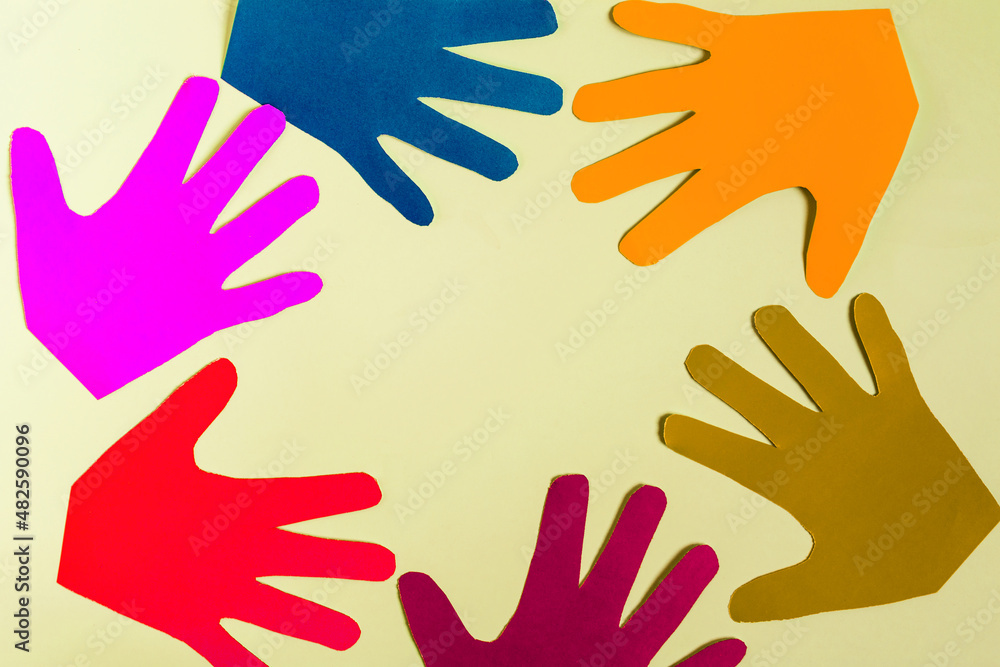 Abstract background multicolored palms made of thick paper on a colored background close-up. Abstract background multicolored palms made of thick paper on a colored background close-up.