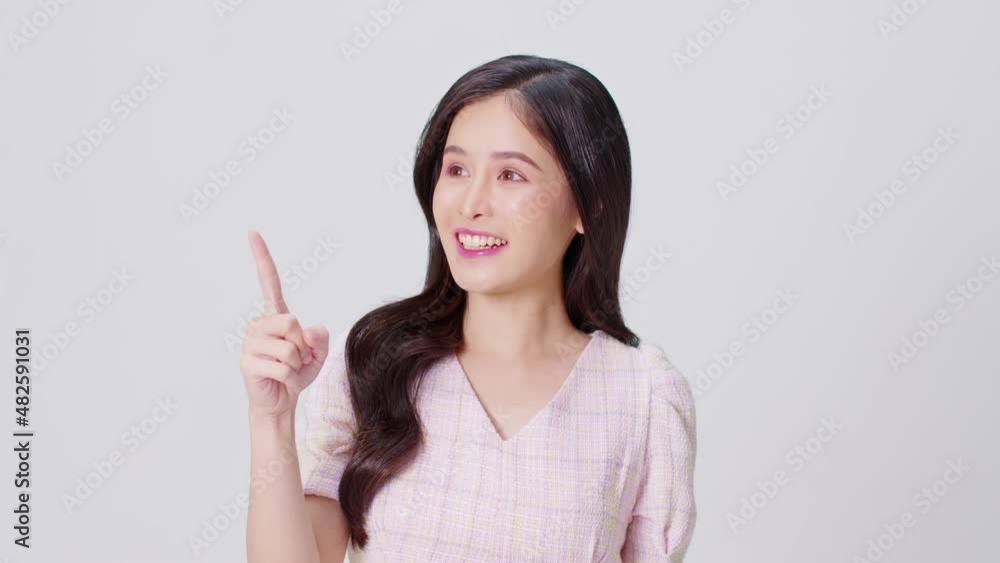 Happy attractive asian young woman thinking an get ideas smile and pointing to copy space isolated on white background.Cheerful pretty girl wear casual dress pointing finger to empty space Happy attractive asian young woman thinking an get ideas smile and pointing to copy space isolated on white background.Cheerful pretty girl wear casual dress pointing finger to empty space
