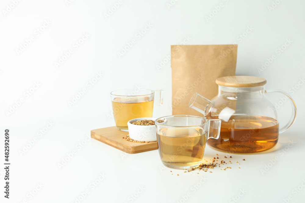Concept of hot drink with buckwheat tea on white background