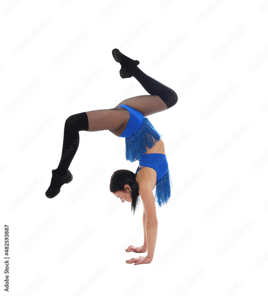 Beautiful cheerleader in costume doing handstand on white background