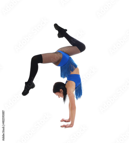 Beautiful cheerleader in costume doing handstand on white background