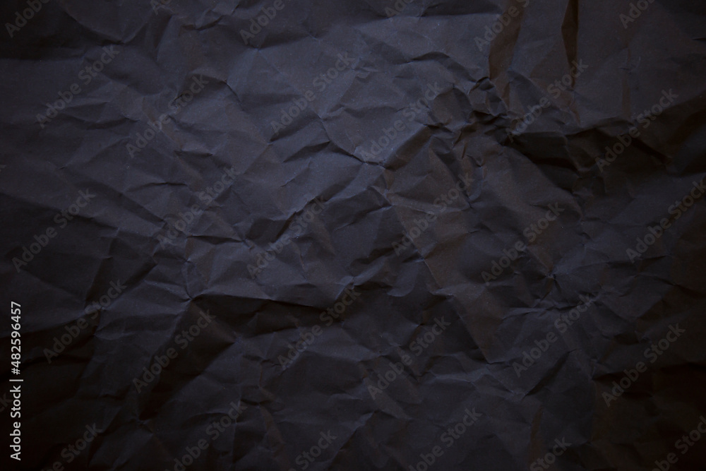 Textured crumpled black paper background. Textured crumpled black paper background.