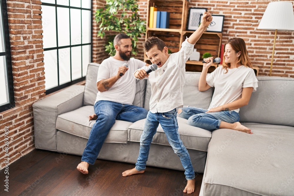Family singing song using microphone at home Family singing song using microphone at home