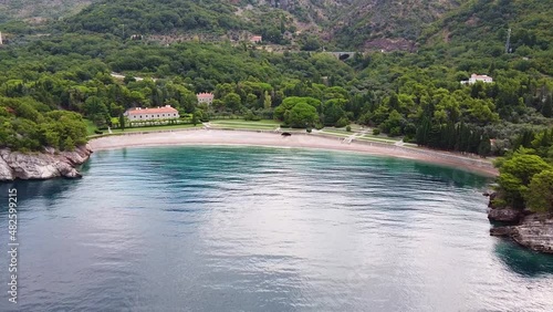Wallpaper Mural Quiet harbor at the foot of the mountain. Several buildings and empty beach. Drone Shot of King's Beach (Milocer Beach) in Montenegro. Torontodigital.ca