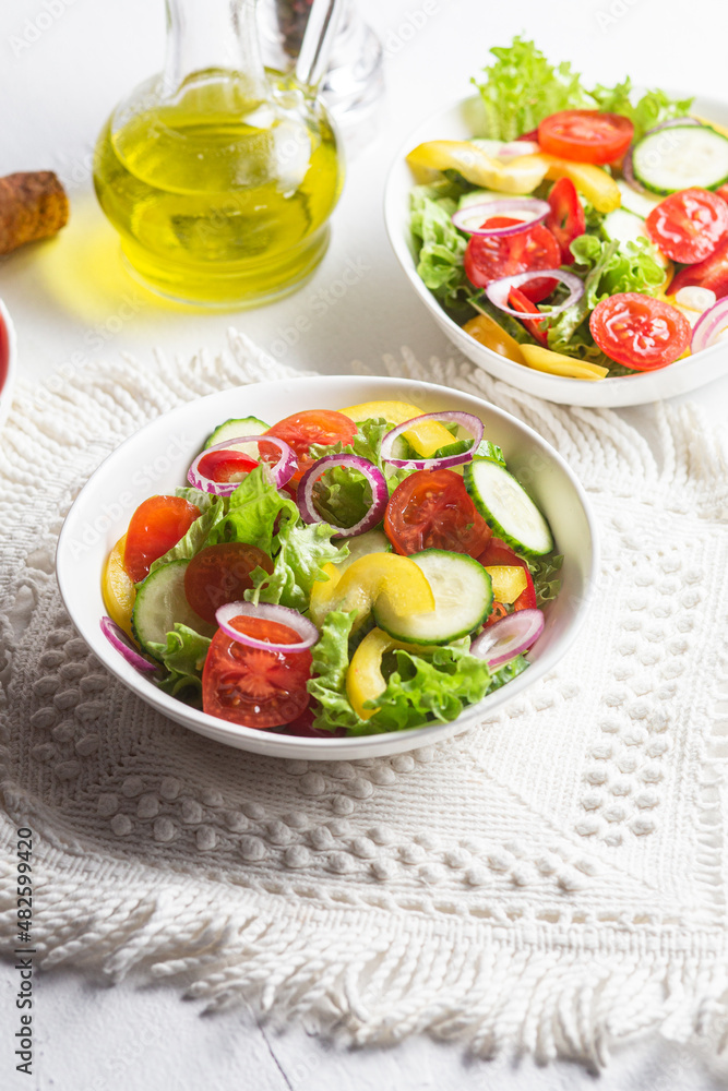 Vegetable salad with cucumber, tomato, sweet pepper in a white plate