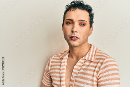 Handsome man wearing make up wearing casual shirt smiling happy pointing with hand and finger © Krakenimages.com