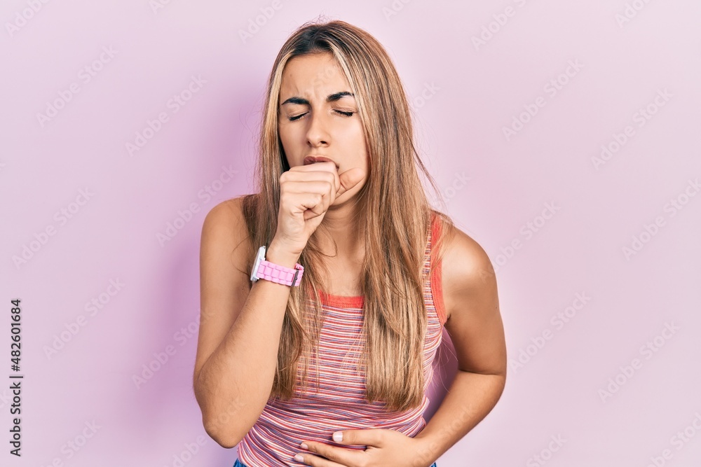 Beautiful hispanic woman wearing casual summer t shirt feeling unwell and coughing as symptom for cold or bronchitis. health care concept. Beautiful hispanic woman wearing casual summer t shirt feeling unwell and coughing as symptom for cold or bronchitis. health care concept.