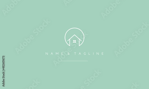 A line art icon logo of a house with a circle.