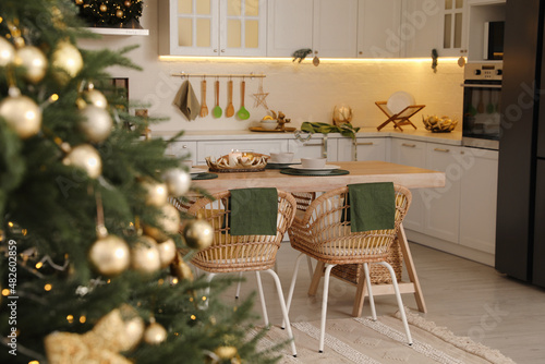 Beautiful Christmas tree in spacious kitchen  closeup. Space for text