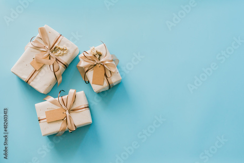 Craft paper gift boxs set on blue background with copy space for text.