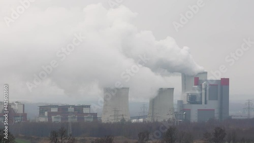 Distant panorama on smoking coal power plant in Bogatynia. Footage taken on a cloudy day, soft light. photo