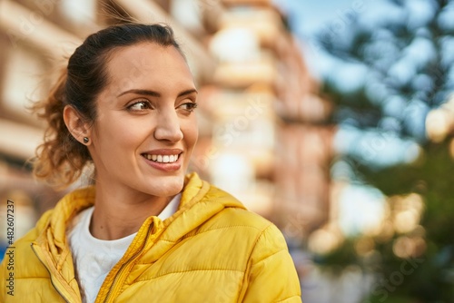 Young hispanic girl smiling happy standing at the city.