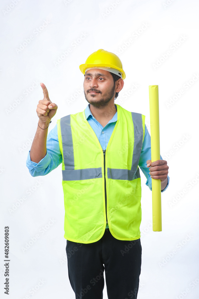 Young architect man with helmet and holding blueprints in hand. on white background. Young architect man with helmet and holding blueprints in hand. on white background.