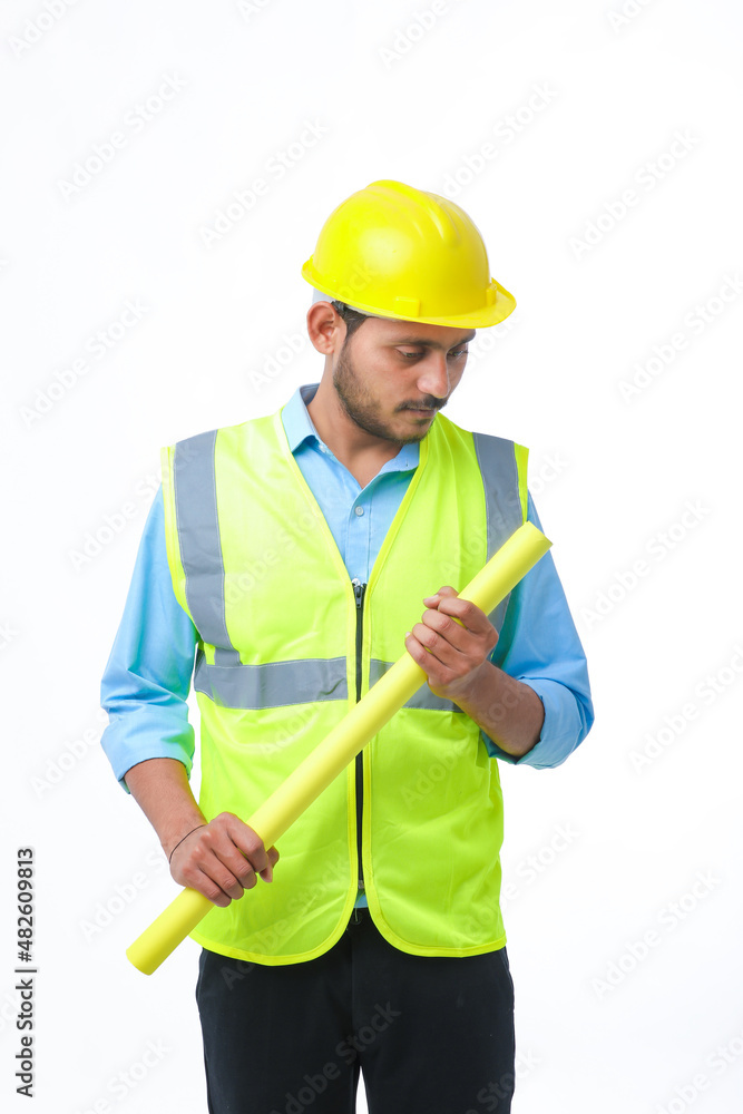 Young architect man with helmet and holding blueprints in hand. on white background. Young architect man with helmet and holding blueprints in hand. on white background.