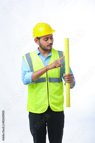 Young architect man with helmet and holding blueprints in hand. on white background.