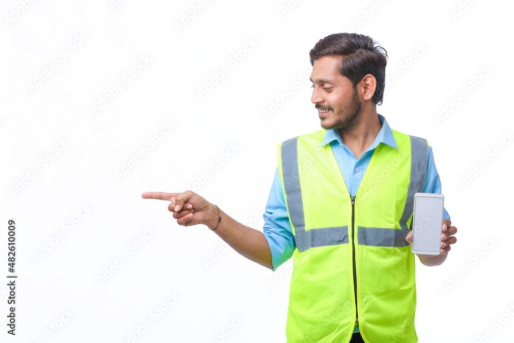Young engineer showing smartphone screen on white background. Young engineer showing smartphone screen on white background.