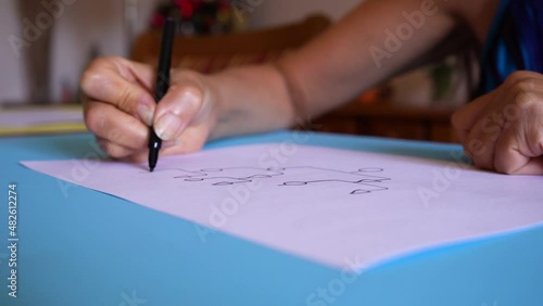 Crop View Of A Person Sketching A Genogram On White Sheet. Closeup photo