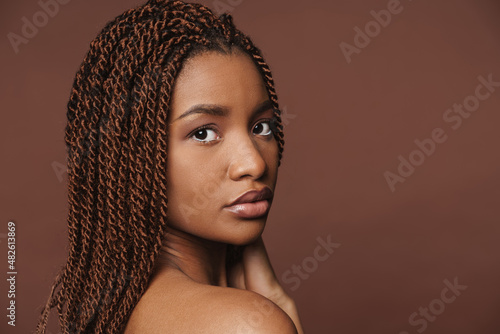 Half-naked black woman posing and looking at camera
