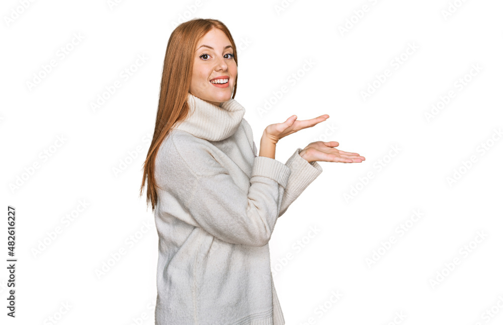 Young irish woman wearing casual winter sweater pointing aside with hands open palms showing copy space, presenting advertisement smiling excited happy Young irish woman wearing casual winter sweater pointing aside with hands open palms showing copy space, presenting advertisement smiling excited happy