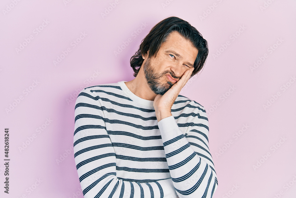 Middle age caucasian man wearing casual clothes thinking looking tired and bored with depression problems with crossed arms. Middle age caucasian man wearing casual clothes thinking looking tired and bored with depression problems with crossed arms.
