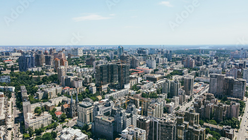Flying over the buildings of the big city. Aerial view of the cityscape © Yarmolovych