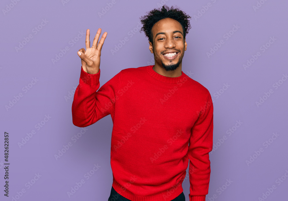 Young african american man with beard wearing casual winter sweater showing and pointing up with fingers number three while smiling confident and happy. Young african american man with beard wearing casual winter sweater showing and pointing up with fingers number three while smiling confident and happy.