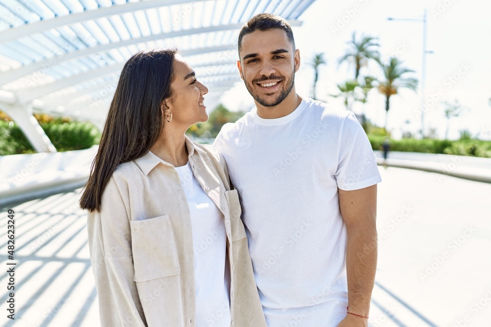 Young latin couple smiling happy and hugging at the city. Young latin couple smiling happy and hugging at the city.