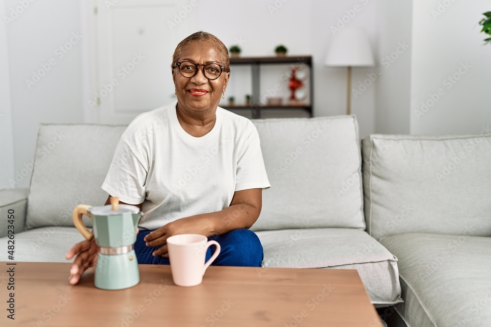Senior african american woman smiling confident drinking coffee at home Senior african american woman smiling confident drinking coffee at home