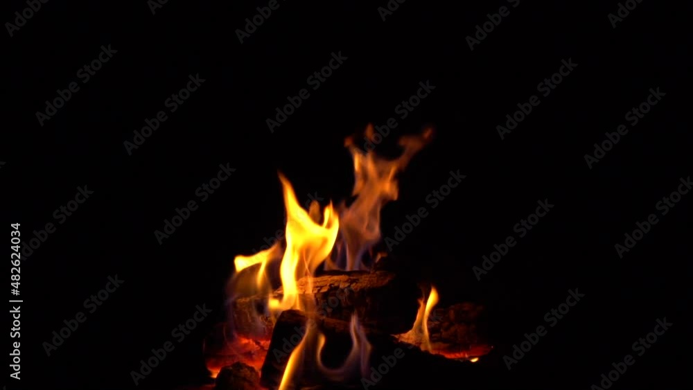 firewood fire burns in dark evening. Flames ripple in wind. wind blows on fire. logs turn to coal and burn in fire. Close up of fireplace with burning wood logs inside. Smoldering charcoal in barbecue firewood fire burns in dark evening. Flames ripple in wind. wind blows on fire. logs turn to coal and burn in fire. Close up of fireplace with burning wood logs inside. Smoldering charcoal in barbecue