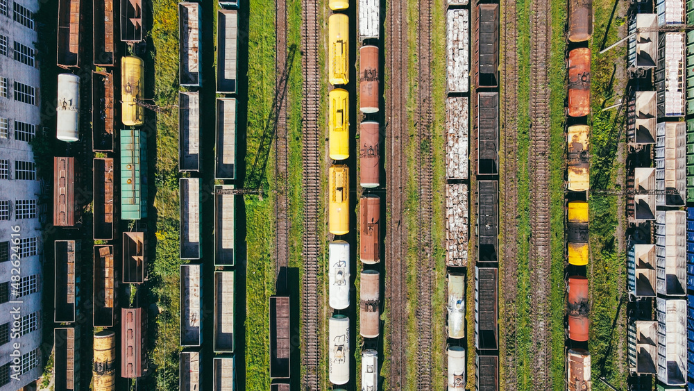 Flying over the depot station of freight trains with cargo ready for delivery