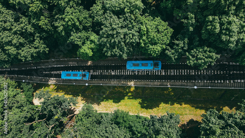 Top view of the funiculars in the park area with tourists going to the station