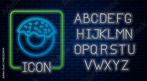 Glowing neon Donut with sweet glaze icon isolated on brick wall background. Neon light alphabet. Vector