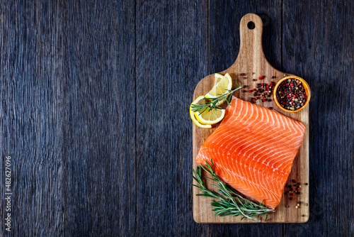 Photography Fresh salmon fish fillet on wooden board